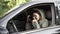 Female private detective with camera spying from car, taking photo with professional camera, close up