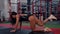 A female professional athlete trains in the gym performs an exercise on the gluteal muscle