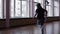 A female professional breakdancer performing in the dance studio, The dark silhouette of dancing girl