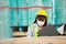 Female professional worker wearing mask safety uniform and hard hat inspect goods on shelves in warehouse. women worker check