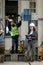 Female project manager in a business suit and white hard hat holds laptop and discusses product details with the chief engineer