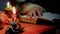 Female psychic invoking the spirits with burning candles, magic and wizards