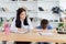 Female psychologist calming cute little boy in office