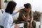 Female Psychologist Comforting Black Soldier Lady During Therapy Session In Office