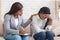 Female psychologist consoling depressed woman at personal consultation in office