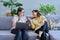 Female psychologist and middle aged woman patient sitting together on couch in office