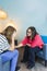 Female psychotherapist supporting and caring for her adolescent patient in therapy.