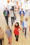 Female Pupil In Classroom Surrounded By Moving Students