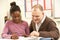 Female Pupil Studying in classroom with teacher