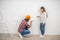 Female purchaser talking to the construction worker and looking unpleased