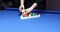 Female puts balls in triangle rack on blue billiard table