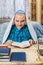 The female rabbi of the Reform Judaism community, shaved bald, prays at the table in the clip.
