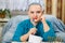 A female rabbi of the Reform Judaism community, shaved bald and wearing a skullcap, draws up a plan of action.