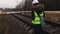 Female railway engineer take pictures of rails before maintenance