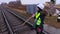 Female railway worker with brush on shoulder