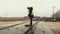 Female railway worker clean railway crossing in winter