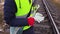 Female railway worker holding wrenches close up