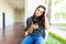 Female Reading News On Mobile Phone While Sitting On Railing