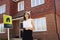 Female Realtor Standing Outside Residential Property