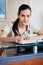 Female Receptionist Writing In Book