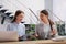 Female receptionists working at desk in hotel