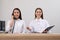 Female receptionists working at desk in hotel