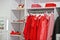 Female red colorful clothing set of on the racks and shelves in clothing store brand new modern boutique. Spring summer dress