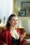 Female with red lipstick in modern living room in sunny day