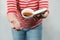 A female in red and white stripy shirt dropping teacup with tea