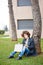 Female redhead art student drawing outdoors