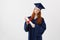 Female redhead graduate student with diploma smiling looking at camera. Copyspace.