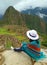 Female Relaxing on the Cliff Looking at Machu Picchu Inca Ruins, Cusco, Urubamba, Archaeological site in Peru