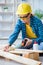 Female repairman carpenter cutting joining wooden planks doing r