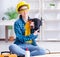 Female repairman carpenter cutting joining wooden planks doing r