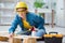 Female repairman carpenter cutting joining wooden planks doing r