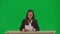 Female reporter isolated on chroma key green screen background. African American woman news host in suit reading