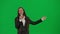 Female reporter isolated on chroma key green screen background. African American woman news host in suit talking in