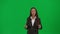 Female reporter isolated on chroma key green screen background. African American woman news host in suit talking