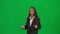 Female reporter isolated on chroma key green screen background. African American woman news host in suit talking