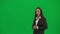 Female reporter isolated on chroma key green screen background. African American woman news host in suit talking