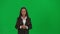 Female reporter isolated on chroma key green screen background. African American woman news host in suit talking