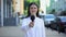 Female reporter proposing microphone, taking interview on street, daily news