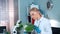 Female research scientist looking on plant under magnifying glass