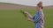 Female Researcher Examining Crop At Field