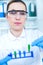 Female researcher with glass equipment in the lab.