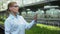 Female researcher looking at plant sample, checking breeding experiment results