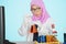 Female researcher pouring chemical liquid on tube