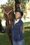 Female rider hugging horse smiling happy