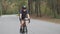 Female riding bicycle in the park. Cycling training. Front follow shot. Fitness on bicycle. Slow motion