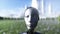 Female robot walks grass field . Sci fi city background. Concept of future. Realistic 4K animation.